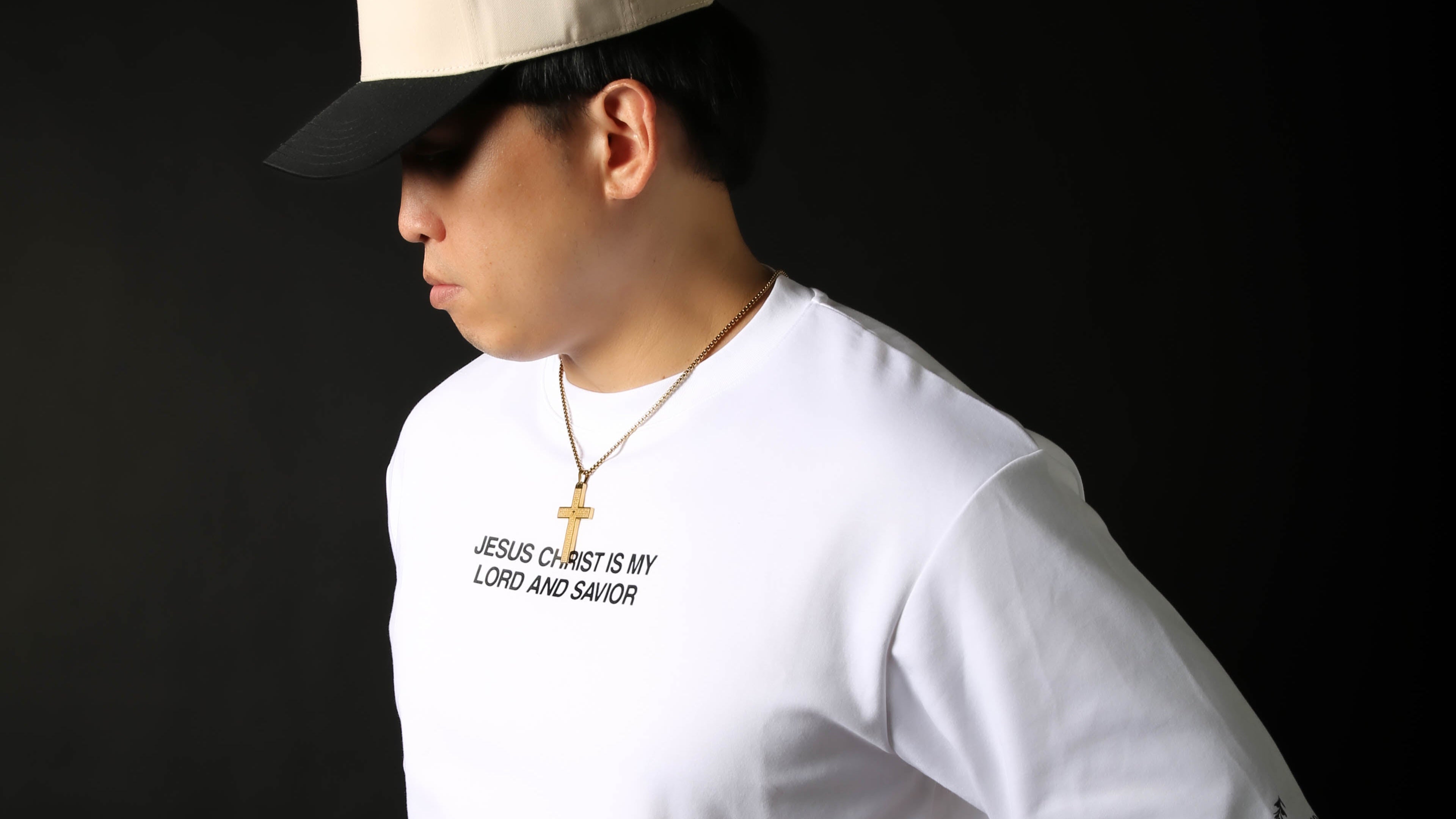 Person wearing a white t-shirt with 'Jesus Christ is my Lord and Savior' text on a black background